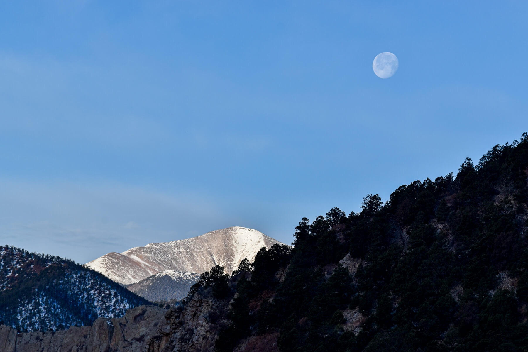 Moon over snowy mountains