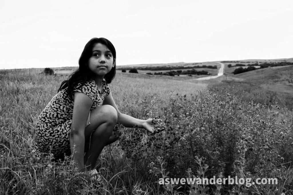 Girl looking up from wildflowers